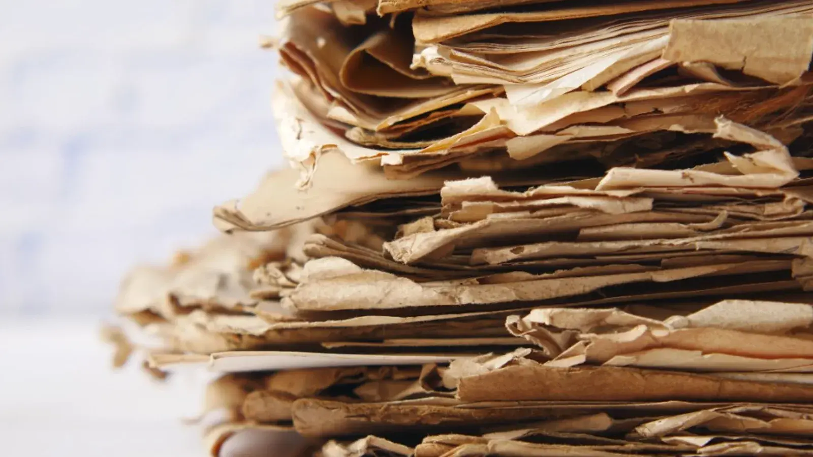 Stack of aged documents representing country evidence and case files
